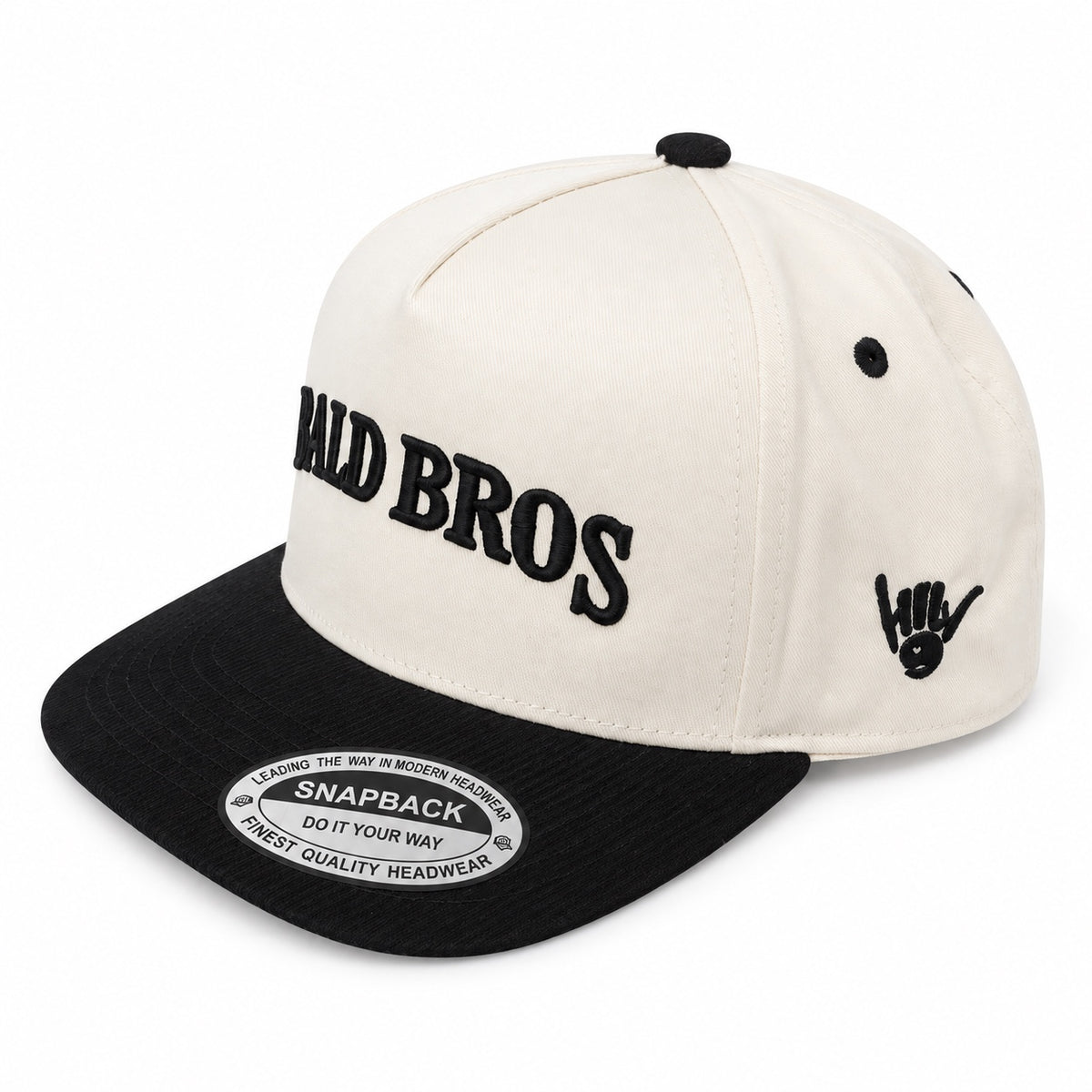 Bald Bros cream and black snapback hat angled view